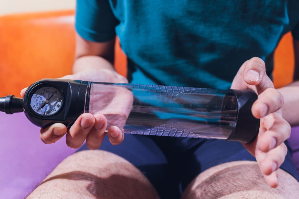 a man holding a penis pump