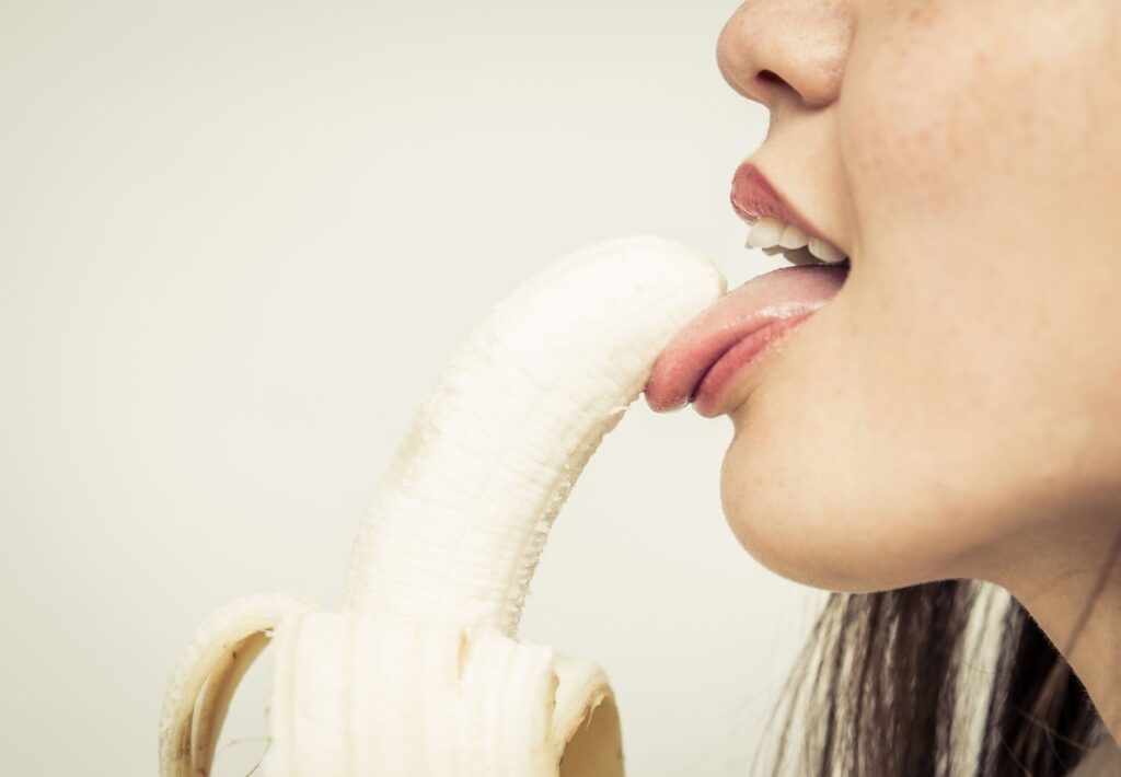 woman licking banana suggestively 
