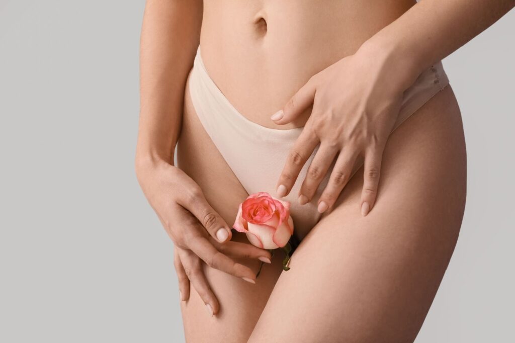 a woman in her underwear holding a rose