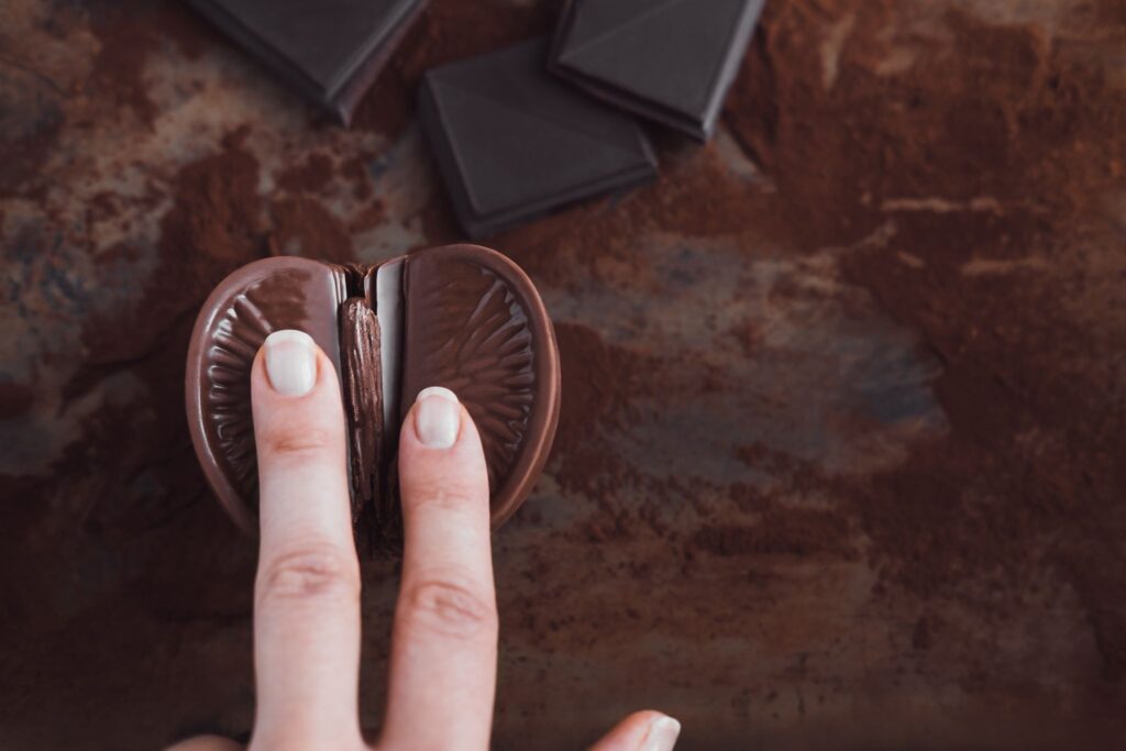 A suggestive chocolate orange with two fingers